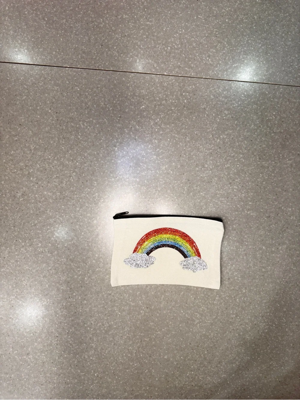 Cosmetic bag with rainbow.  Design is on both sides.  8 x 5